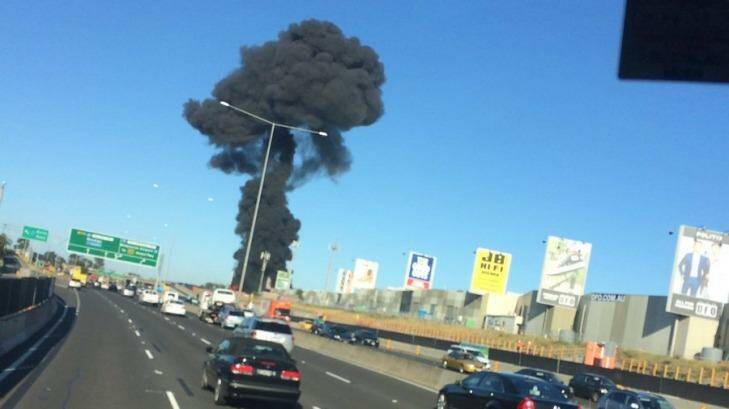 A large plume of black smoke can be seen near the DFO in Essendon. Photo: Thomas Maggs / Twitter