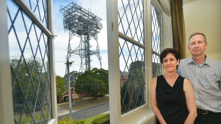 Anne Fleming and her husband Colin Peace, and the view of the tower from their Surrey Hills home. Photo: Joe Armao