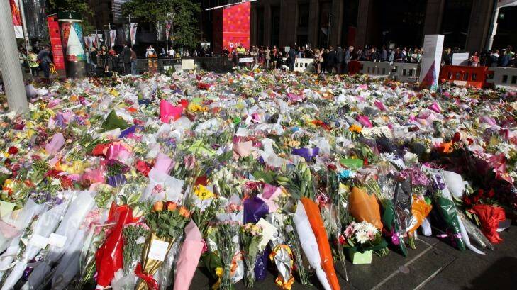 Tribute: The memorial to the victims of the Lindt cafe siege continued to grow in Martin Place on Wednesday. Photo: Peter Rae
