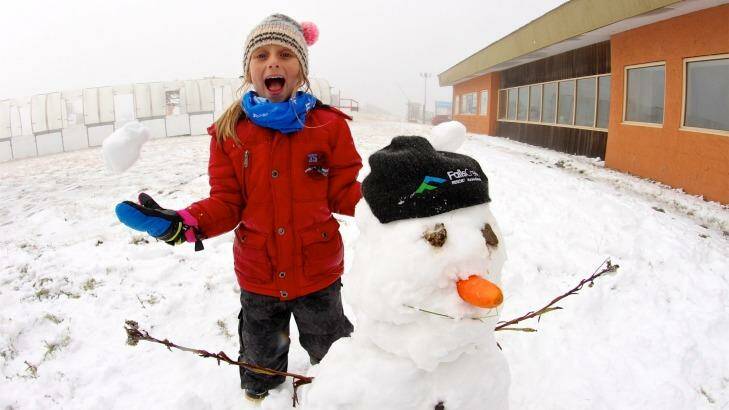 Jacinta Jansen, aged seven, with her first snowman for the year at Falls Creek. Photo: Chris Hocking