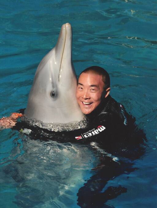 Deakin University Warrnambool marine science graduate Jon Lau gets up close with a dolphin. Picture: Supplied