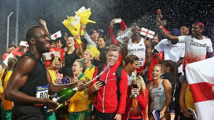 Usain Bolt celebrates with champagne. Photo: Scott Barbour