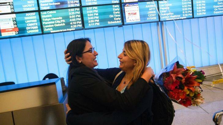 Sahar Muranovic, left, embraces her sister Sara Yarjani, an Iranian student who was detained for 23 hours and deported, as they are reunited at Los Angeles International Airport. Photo: New York Times
