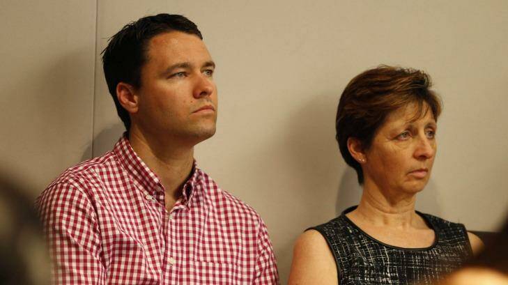 Ken Lay's son, Scott, and wife, Christine, watch on as the chief commissioner stands down. Photo: Eddie Jim