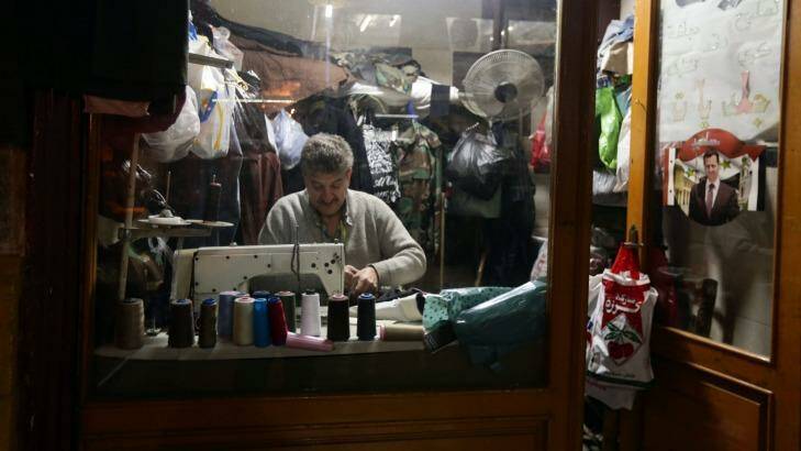 Bunkered down: Life goes on for this Damascus tailor despite the war on the streets outside.  Photo: Louai Beshara
