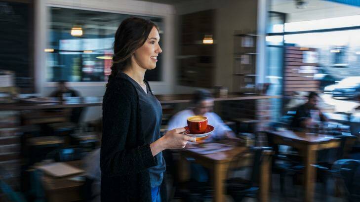 Sophie Briedis delivers a coffee at Ona coffee shop in Fyshwick. Ona offered customers limited cups of Sestic's award-winning signature brew on Wednesday. Photo: Rohan Thomson