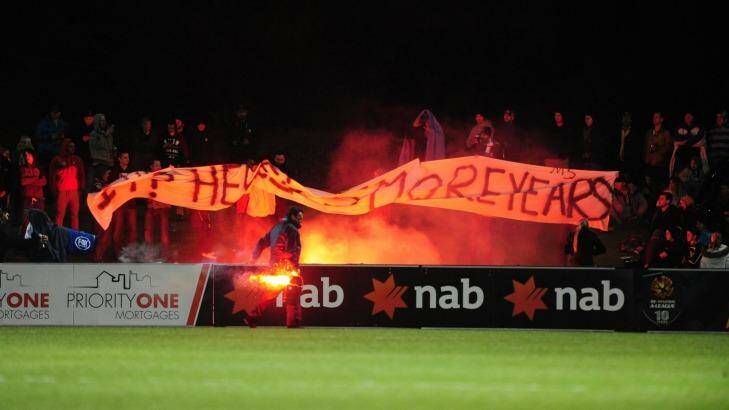 A flare is set off at the match between Tuggeranong United and Melbourne Victory. Photo: Melissa Adams