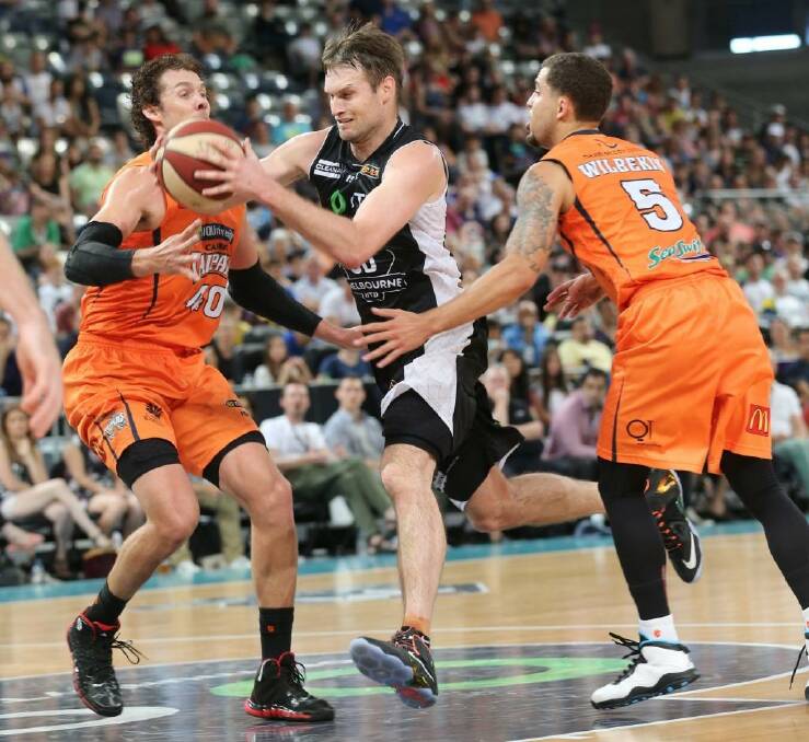Crowded lane: Melbourne United veteran Mark Worthington tries to evade the Cairns defence. Photo: Mick Connolly