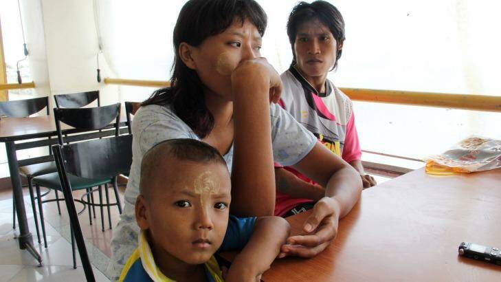 Khine Zin Soe, 24, centre, worked in a shrimp shed when she was pregnant and the owner forced her to work peeling shrimp even when she miscarried. With her are her husband, Kyaw Kyaw Aung, and her son, Htet Wai Yan.  Photo: Esther Htusan