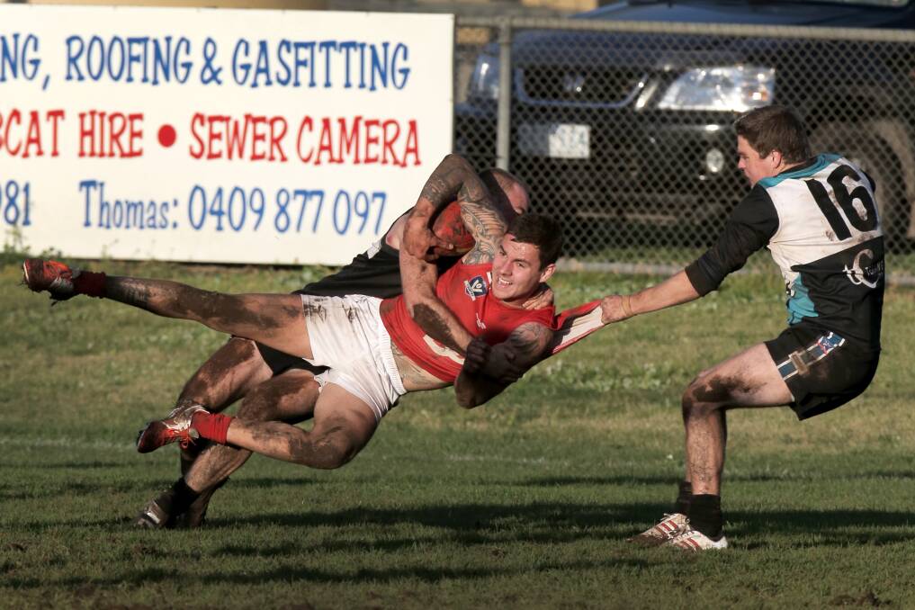 WDFNL Kolora-Noorat v Dennington Football. Pictured -D #8 Brandon Edwards is slung in the tackel of KN #48 Nathan Cahir and KN #16 Stephen O'Connor. 140726RG86 Picture: ROB GUNSTONE