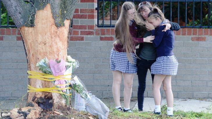 Grieving friends pay their tributes at the scene. Photo: Justin McManus