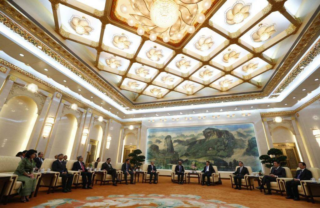 China's President Xi Jinping (fourth right) meets guests at the Asian Infrastructure Investment Bank (AIIB) launch ceremony in the Great Hall of the People in Beijing in October last year. Photo: POOL