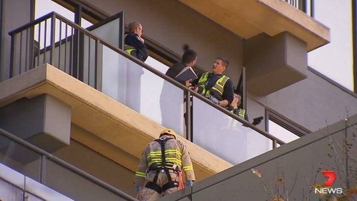 MFB crews perform a high-angle rescue to retrieve a woman who fell onto a roof in the CBD. Photo: Channel Seven