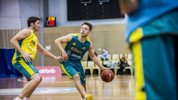 Matthew Dellavedova (right) is guarded by Damien Martin at the Australian Boomers training camp at the AIS on Thursday. Photo: Rohan Thomson