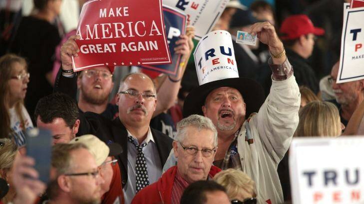 Attendees hold signs as Donald Trump, 2016 Republican presidential nominee speaks during a campaign event in Colorado Springs, Colorado. Photo: MATTHEW STAVER