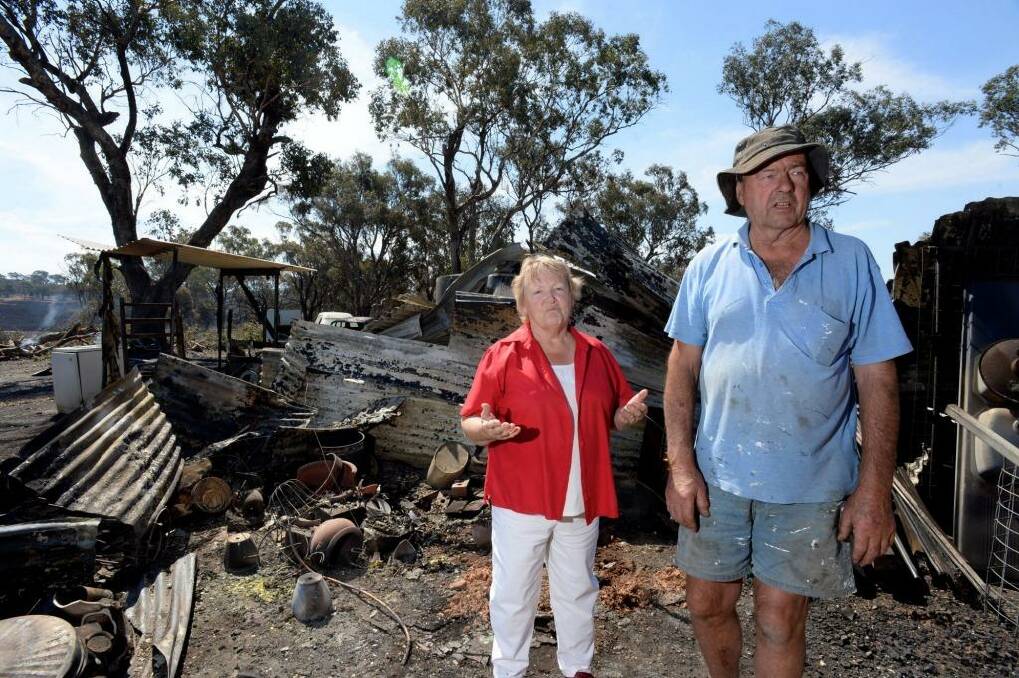 Bob and Jane Derrick at their Boweya farm assessing the fire damage.  Photo: Penny Stephens