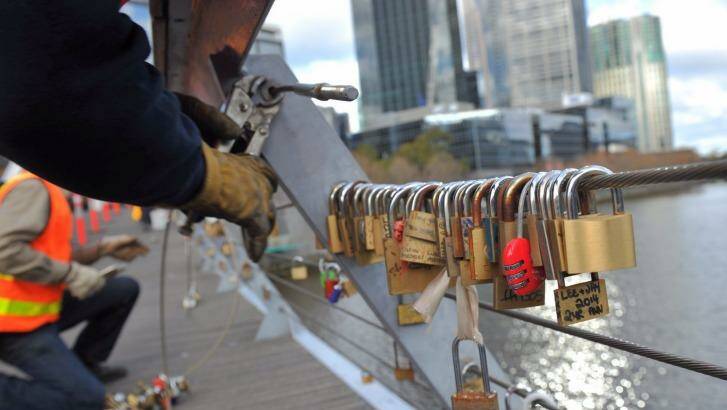 Council workers remove locks over the Yarra on Thursday.  Photo: Joe Armao