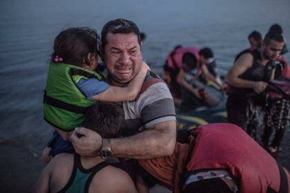 The image of Syrian refugee Laith Majid and his children has struck a chord with thousands on social media. Photo: Daniel Etter