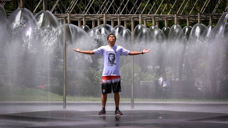 English student Keanu Audabram from New Caledonia cools down at the fountain on Spring Street. Photo: Eddie Jim