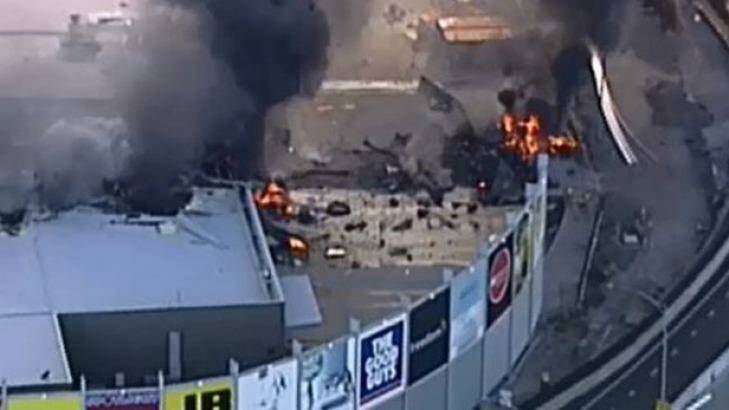 The fiery aftermath of the plane crash at DFO Essendon.  Photo: Channel 9
