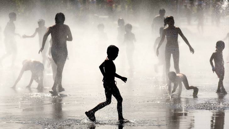Children cool off under a fountain in Madrid in July this year. Photo: Pablo Blazquez Dominguez