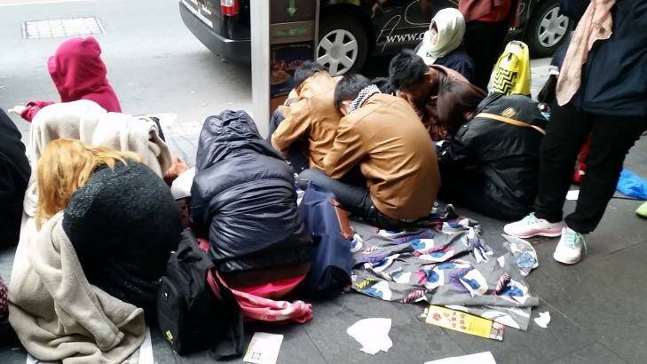 Exhausted from a long wait, many queuers are literally sleeping on the streets in Sydney. Photo: Hannah Francis