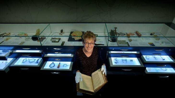 Dr Christine Ball at Melbourne's Geoffrey Kaye Museum of Anaesthetic History with a 1558 translation of Hippocrates' writings. Photo: Simon Schluter