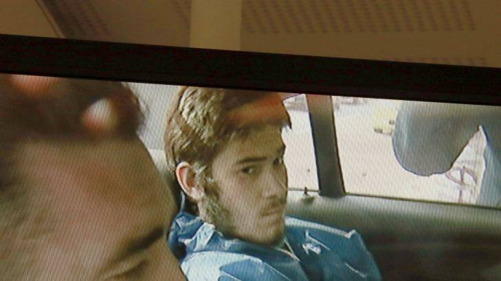Sevdet Besim in the back of a police car after his arrest. Photo: Channel 9