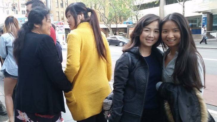 At 7.50am, Rini Marsita, 27, and her sister Rika, both from Waterloo, were last in the line that snaked 400 metres from the apple store in George St, down York and Market streets to Clarence St - a 5 minute walk to the Apple store. Photo: Hannah Francis