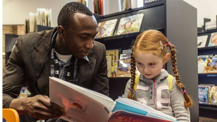 Omotayo Daib with Matilda Barry at the Kathleen Syme Library and Community Centre in Carlton. Photo: Meredith O'Shea