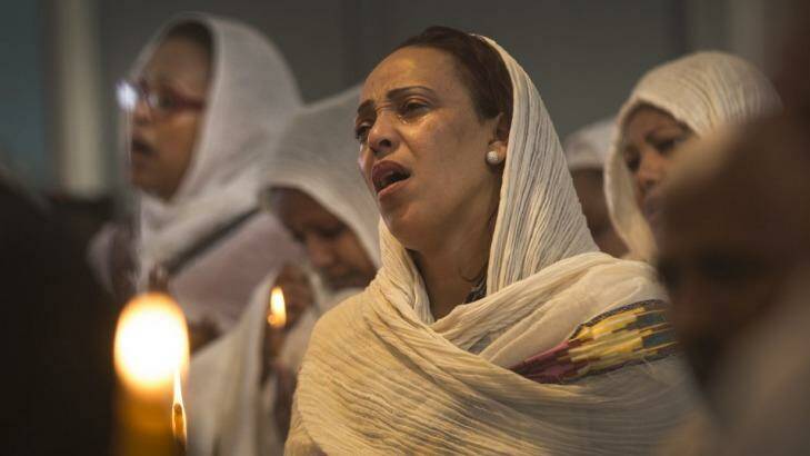 Sosena Neguss from Caroline Springs sheds tears during a memorial for the 30 Ethiopians killed by Islamic State earlier this week. Photo: Simon O'Dwyer