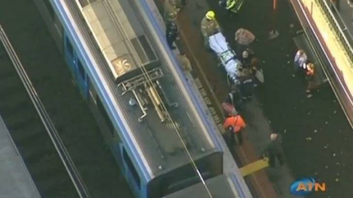 The woman is taken from Malvern station on a stretcher. Photo: Australian Traffic Network