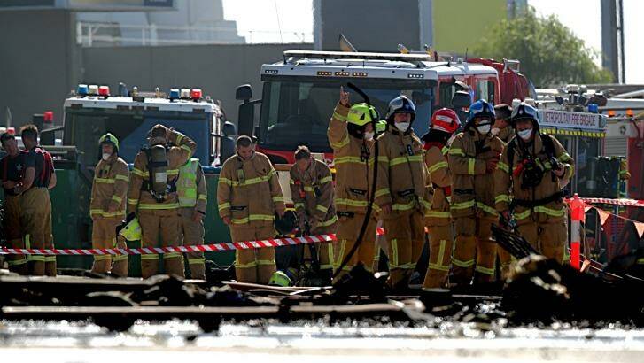 Firefighters at the scene of the plane crash at Essendon Fields.  Photo: Jason South