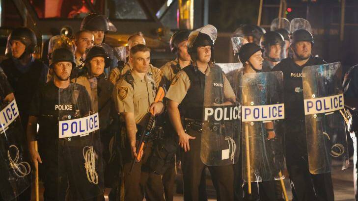 Police watch as demonstrators protest at the killing of teenager Michael Brown. Photo: Getty Images/Scott Olson