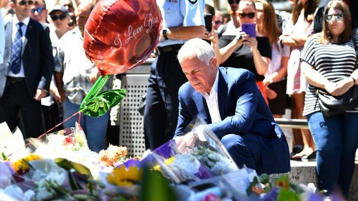 Prime Minister Malcolm Turnbull lays flowers in Bourke Street. Photo: Joe Armao