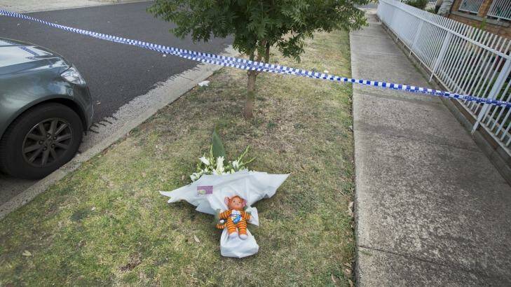 Flowers and a toy left outside the home where a woman and boy were found dead in Albanvale. Photo: Simon O'Dwyer