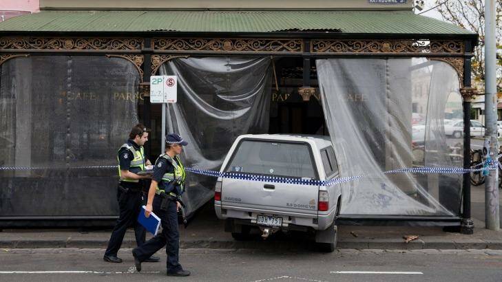 Police inspect the ute that smashed into Carlton's North's Paragon Cafe in June last year.  Photo: Paul Jeffers