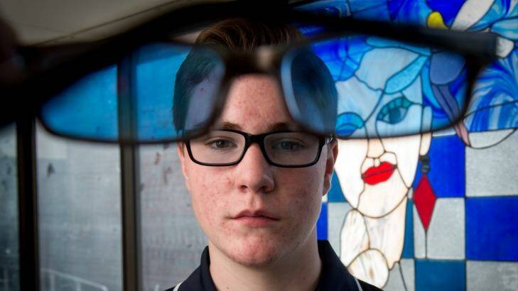 Silas Dewney, 14, says his colored glasses have helped with his dyslexia.  Photo: Penny Stephens