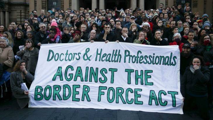 Doctors and health professionals at a Sydney protest last year. They stood with their hands over their mouths indicating they are being silenced by the new laws. Photo: Fiona Morris