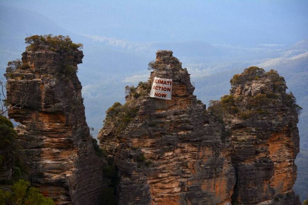 Human intervention: a banner hangs off the Three Sisters on Sunday. Photo: Ireni Clarke