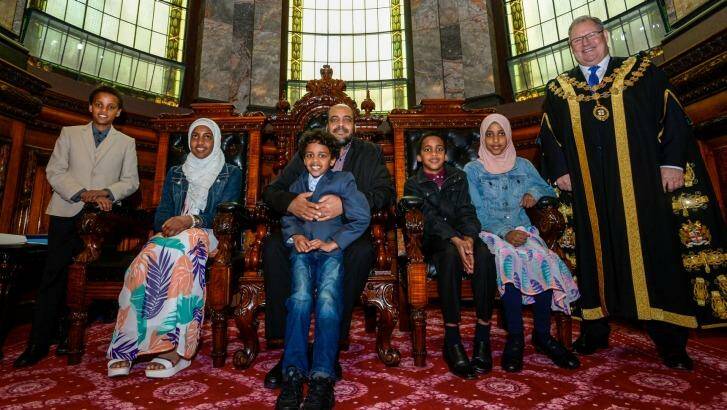 Joining Abubeker Mohamed and Lord Mayor Robert Doyle at the ceremony are his family Abdullah, Nusayba, Osama, Mohamed and Hajer. Photo: Justin McManus