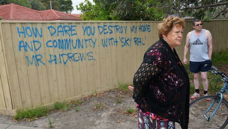 Noble Park resident Gina and son Chris Papapavlou with their angry message to Daniel Andrews.  Photo: Joe Armao