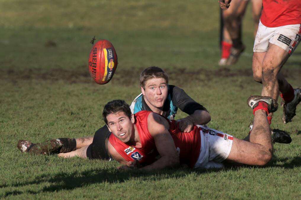 Dennington s Dustin McCorkell and his Kolora-Noorat tackler Stephen O Connor get a ground-level view of an escaping football. 140726RG82 Picture: ROB GUNSTONE 
WDFNL Kolora-Noorat v Dennington Football. Pictured - D #5