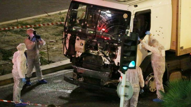 Authorities investigate the truck that drove through Bastille Day crowds in Nice late on Thursday night. Photo: Sasha Goldsmith/AP