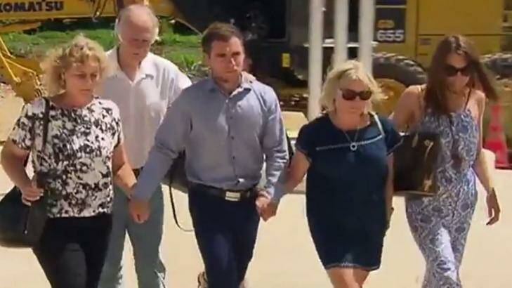 Thomas Keating (centre) arriving at Phuket police station on February 9 with members of his family, and the family of his late girlfriend Emily Collie. Photo: Twitter/@7NewsMelb