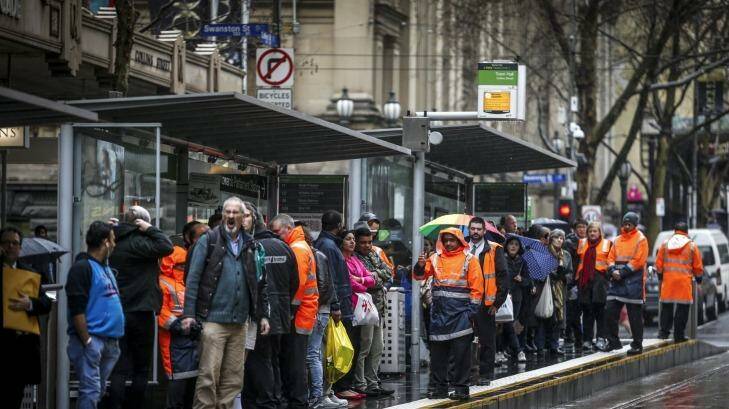 Passengers wait at a tram stop on Thursday morning ahead of the strike starting.  Photo: Eddie Jim