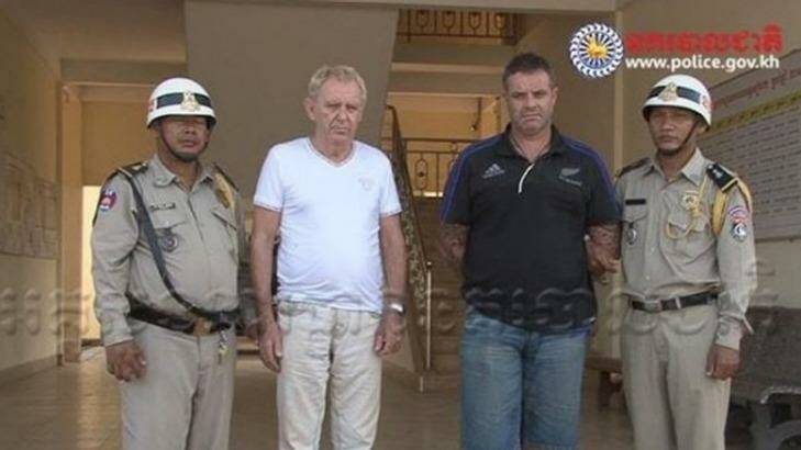 Victorian man Guido James Eglitis (left) and another foreign suspect under arrest in the Cambodian town of Siem Reap last year. Photo: Cambodian Police