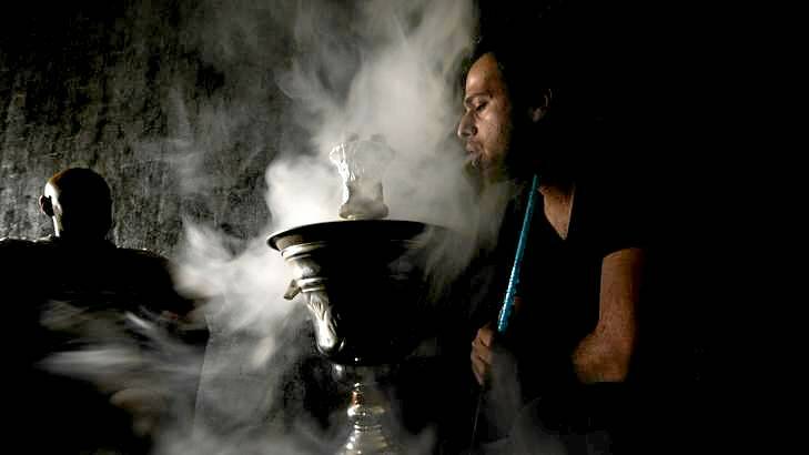 Saddique Baig smoking a Shisha pipe at the Arabesque Shisha lounge in Coburg. Photo: Justin McManus
