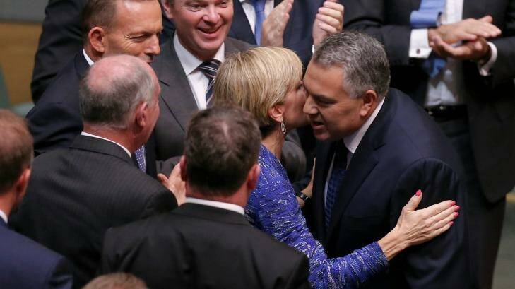 Business has praised a "softer, cuddlier budget" from Treasurer Joe Hockey, seen here congratulated by Foreign Affairs Minister Julie Bishop after handing down the Budget, but foreign aid recipients will suffer. Photo: Alex Ellinghausen