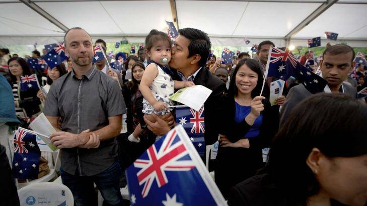 Michael Bulanan giving his two year old daughter Zorawar Singh a kiss while his wife Rachelle Bulanan watches on at the Australia Day ceremony in Sunshine. Photo: Simon O'Dwyer